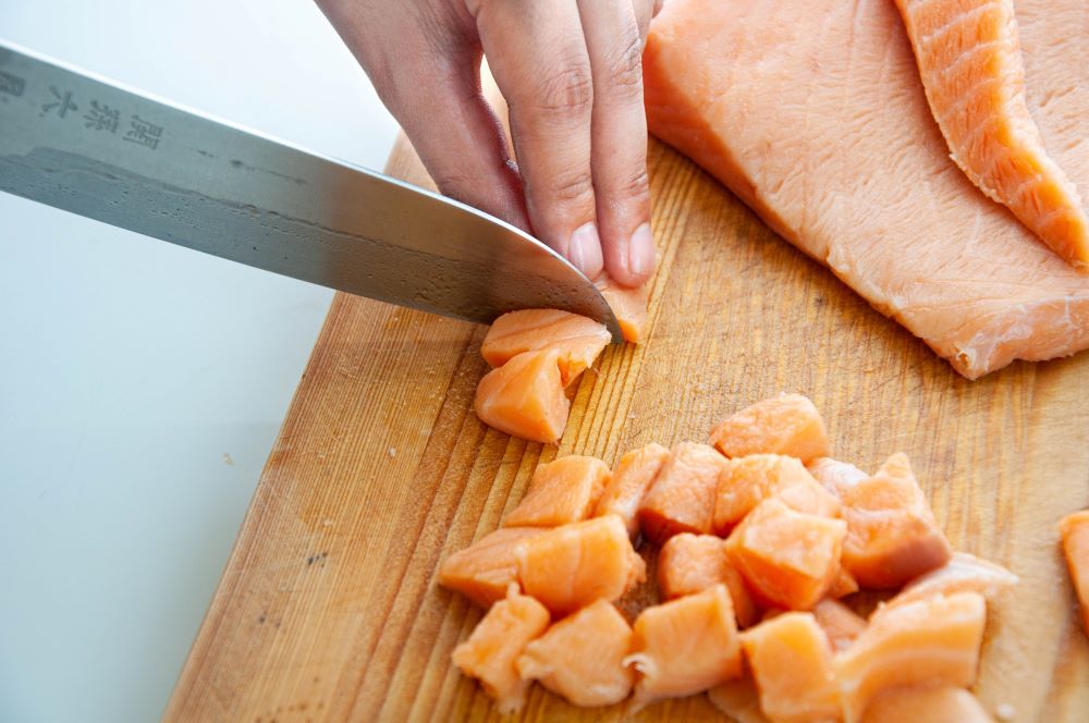 Slicing the salmons into diced pieces