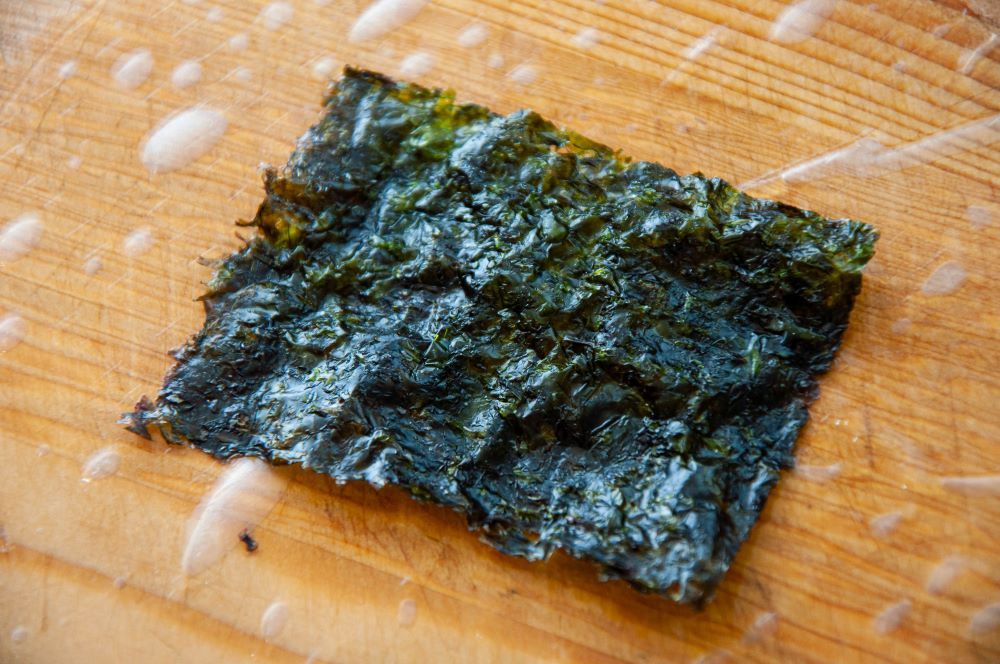 Placing a sheet of nori in the center of the rice paper