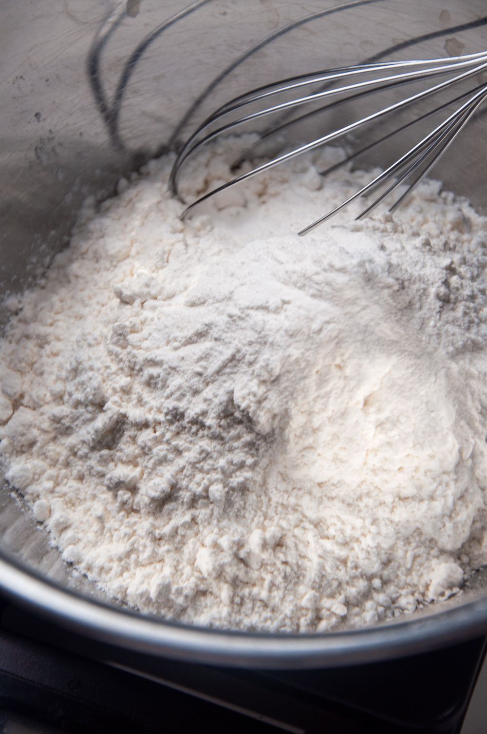 Mixing flour with a whisk to make miso cookies