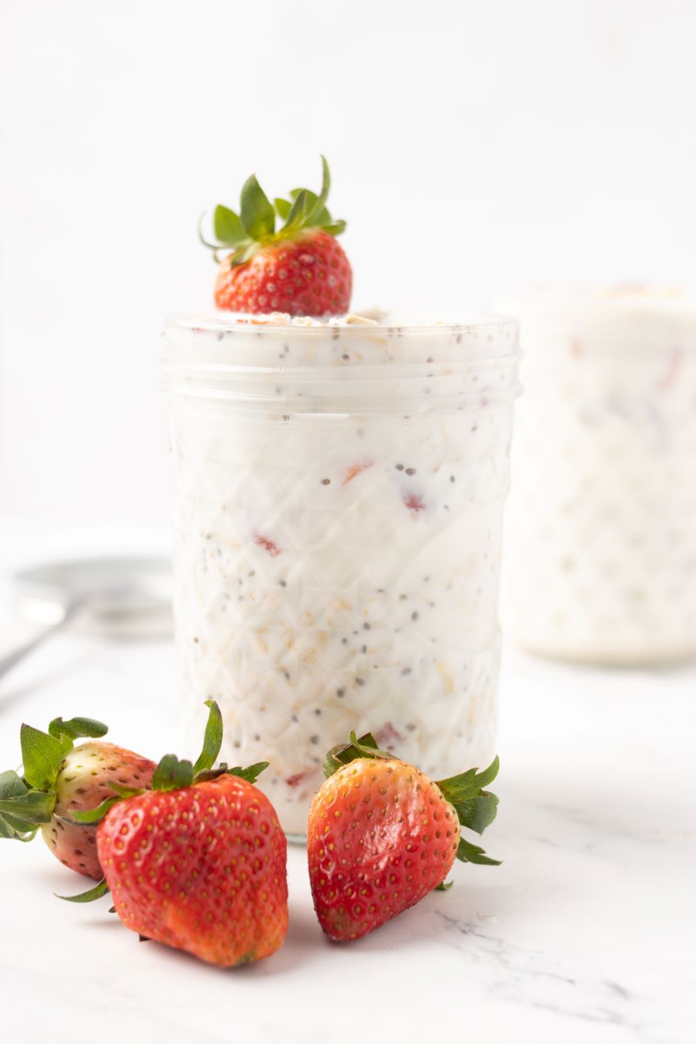 Strawberry Overnight Oats with three strawberries