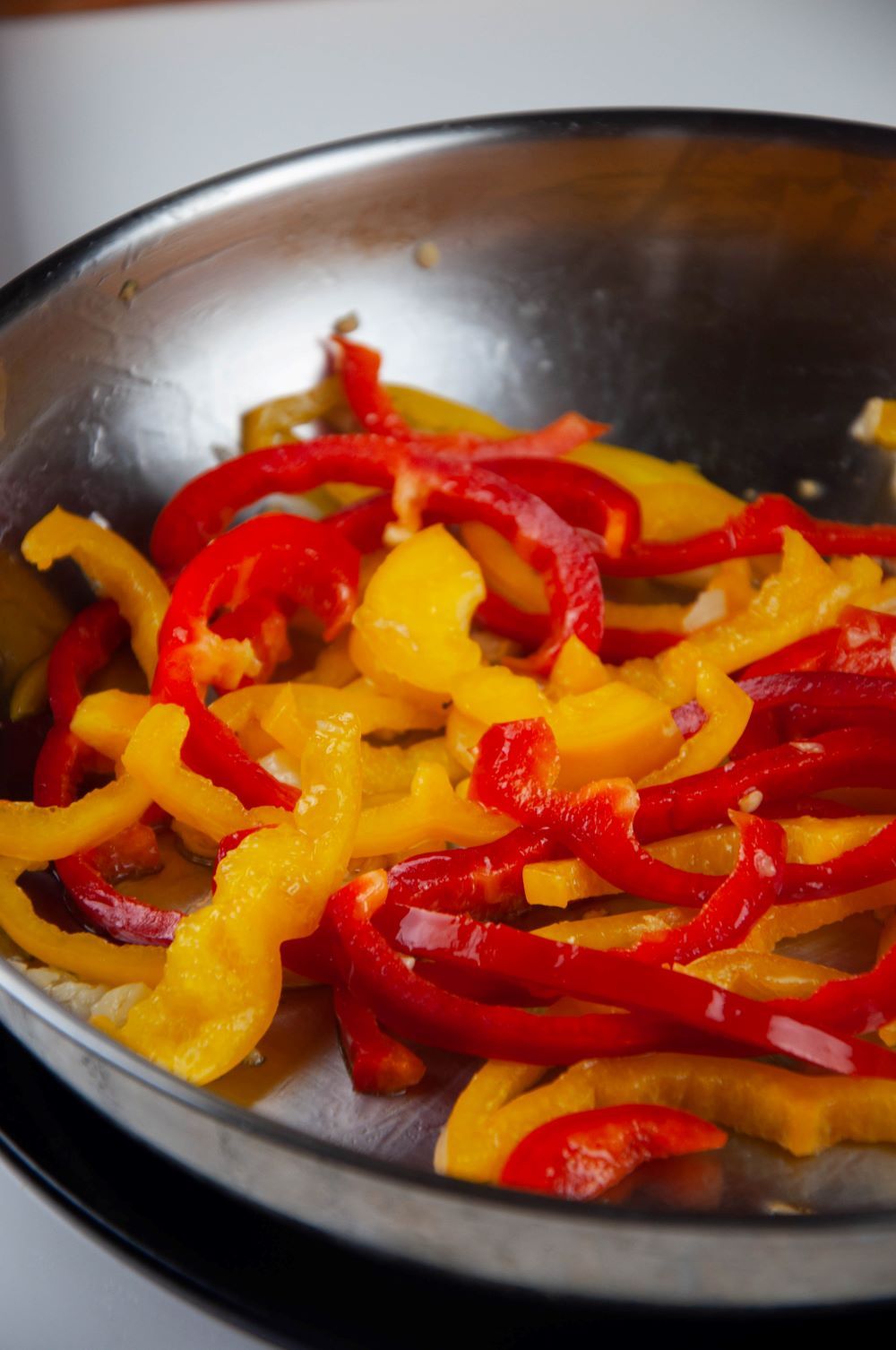 Stir-frying the bell peppers